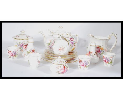 A Royal Crown Derby four person breakfast tea service in the Derby Posies pattern consisting of teapot , egg cups , cups and 