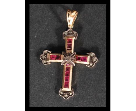 An Italian 14ct gold ruby and diamond crucifix pendant being set with 10 square cut rubies of approx 2.5mm each the pendant c