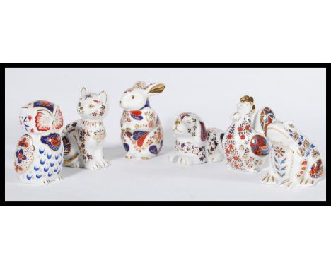 A collection of six imari pattern ceramic paperweights in the form of animals to include dog , cat , chicken , frog , owl and