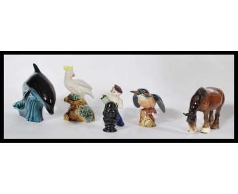 A collection of ceramics to include a Poole pottery dolphin, a Brazilian Cockatoo, a Beswick horse and a Kingfisher. Highest 