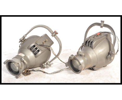 A pair of vintage 20th Century theatre / stage lights possibly by strand lighting of usual form, hanging brackets to the top.