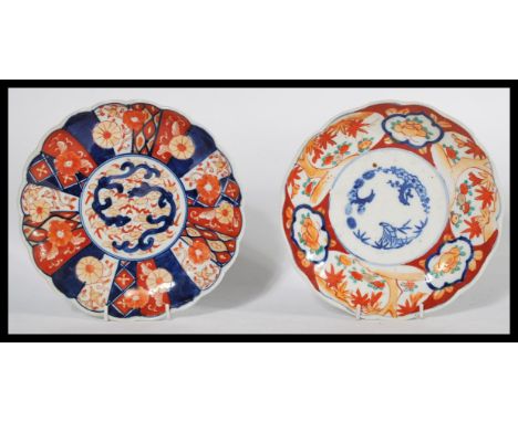 Two 19th century Japanese Imari charger plates of scalloped form , one having a central cartouche with two fighting dragons w