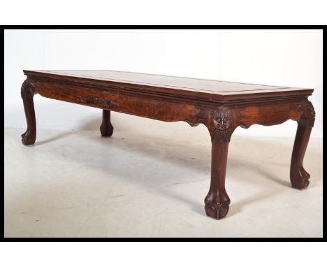 A Chinese mid century rosewood coffee table of rectangular form inset with soapstone relief adorned panel scenes. All raised 