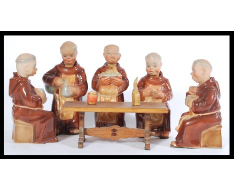 A group of five vintage 20th Century ceramic&nbsp; decanters modelled as monks, sat around a miniature refectory table. Highe