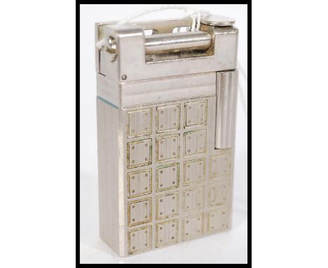 A vintage 20th century French Dupont lighter in silver metal having for dice pattern throughout. Stamped to base.