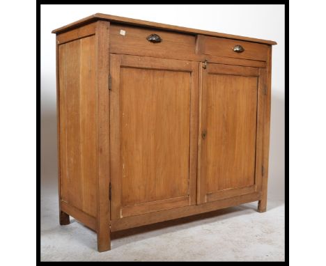 An early 20th Century Elm Buffet having two drawers over two panel doors...