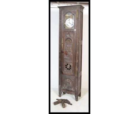 A 19th century French chestnut / oak large Breton compoise longcase clock having&nbsp; oversized trunk and hook with decorati