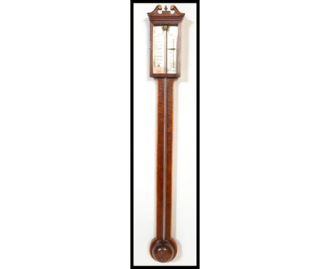 A 19th century Georgian stick barometer. The mercury barometer with mahogany backing having thermometer with silvered dial. D