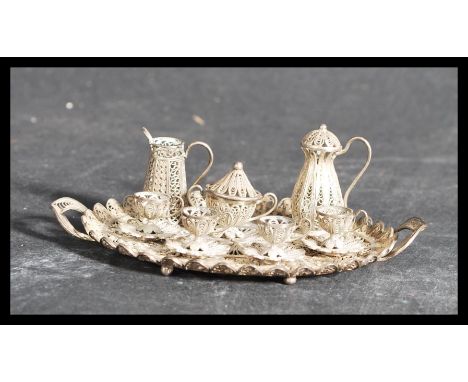A 19th century Victorian silver filigree miniature dolls house tea service on twin handled gallery tray consisting of four cu