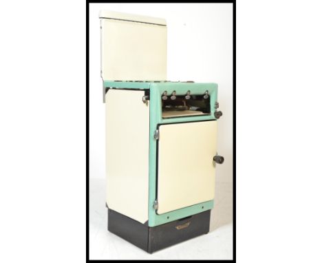 A vintage mid 20th Century two tone enamel gas cooker by Cannon having three ring burner over grill and separate oven with me