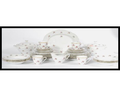 A vintage bone china tea service in the manner of Old Country Roses consisting of tureens , plates etc. Makers stamp to base.