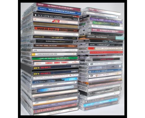 A collection of Compact Discs CD's featuring several artists and genres to include Dave Brubeck, Robbie Williams, The Maveric