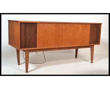 A 1960's teak wood Dynatrom stereogram. The teak case on tapered legs with grill speaker facia. Inset Garrard deck with radio