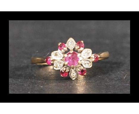 A hallmarked ruby and diamond cluster ring. Hallmarked London. Weight 2g. Size M.5.