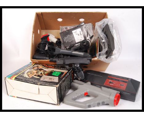 An assorted collection of vintage electronic games consoles and accessories to include a Sega Master System , Light guns , in