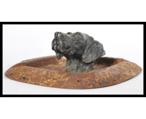 A very rare early 20th century Camwal Table Waters advertising point of sale ashtray having central spelter dog head. Embosse