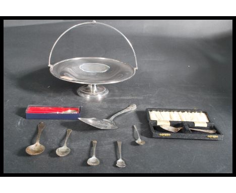 A group of silver hallmarked and sterling silver flatware along with a silver plated tazza pedestal bowl with handle atop. Pl