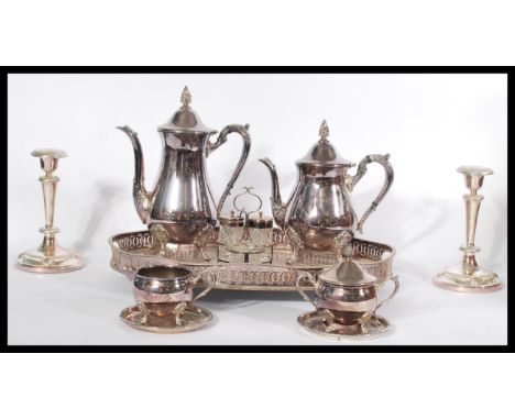 A Viners silver plated four piece tea service set along with a silver plated candlestick , cut glass cruet set , coasters etc