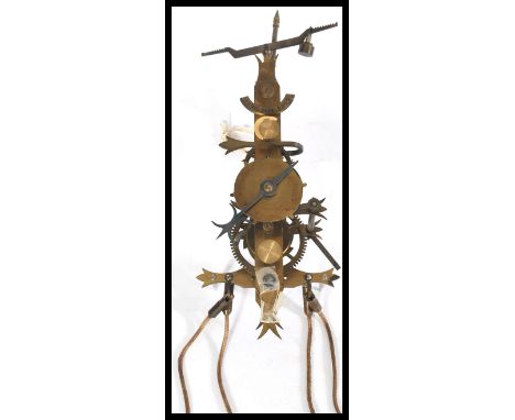 A seven day skeleton lantern style wall clock with single weight driven movement and pendulum, striking on a bell. Measures 3