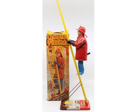 Marx: A boxed Louis Marx, Climbing Fireman, No. 735, circa 1950's, in original box, written-on, heavy creasing and wear to ed