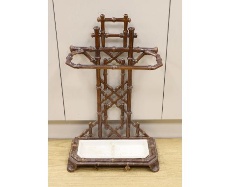 A French faux bamboo brown enamelled iron stick stand, 71cm tall