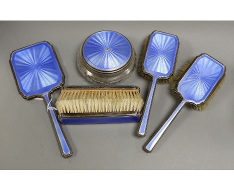 A 1930's silver and blue guilloche enamel six piece dressing table set, including hand mirror and toilet jar.