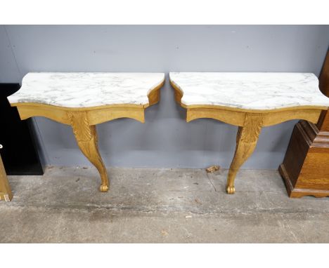 A pair of Victorian style marble topped serpentine giltwood console tables, width 84cm, depth 44cm, height 79cm