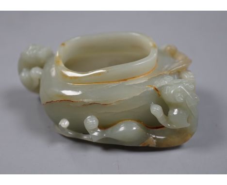 A Chinese celadon jade brushwasher, dragons
