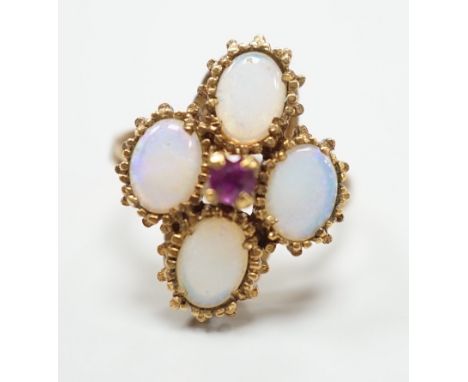 A 1970's  9ct gold, four stone white opal and single stone ruby cluster set dress ring, size O, gross weight 5.2 grams.