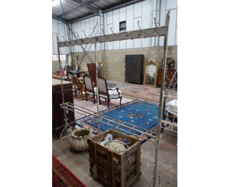 A vintage wrought iron coat and stick stand, width 200cm, height 206cm