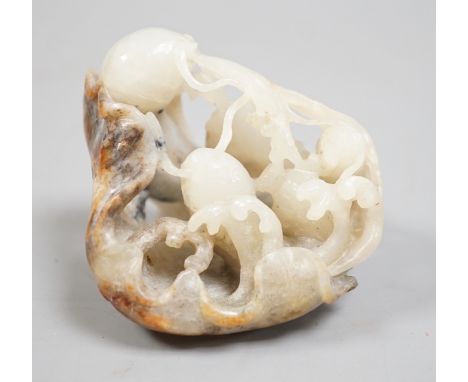 A Chinese pale grey and russet jade carving of carp amid lotus, 7.3 cm