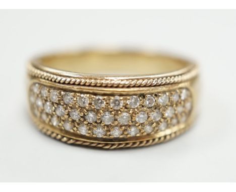 A modern 9ct gold and pave diamond chip set ring, size M/N, gross weight 4.5 grams.