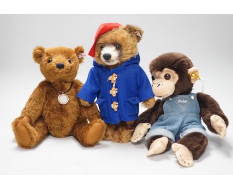 Three boxed Steiff toys: a Paddington bear, a brown bear and a monkey,