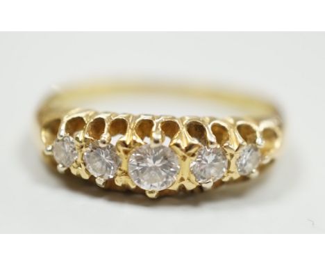 An early 20th century gold and graduated five stone diamond set half hoop ring, size O/P, gross weight 4.3 grams.