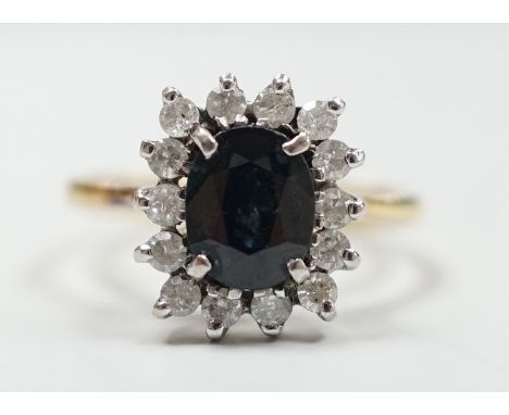 An 18k yellow metal, sapphire and diamond set rectangular cluster ring, size M, gross 4 grams.