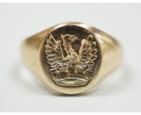 A yellow metal crested signet ring, carved with eagle above coronet, size G, gross weight 3.8 grams.