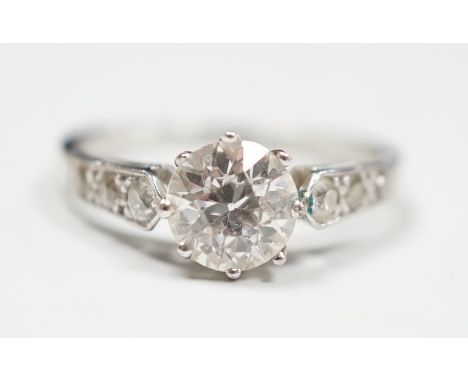 A mid 20th century white metal (stamped Plat) and single stone diamond ring, with diamond set shoulders, size J, gross 2.6 gr