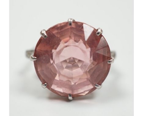 A white metal and circular cut pink topaz set dress ring, with three stone graduated diamond set shoulders, size I/J, gross w