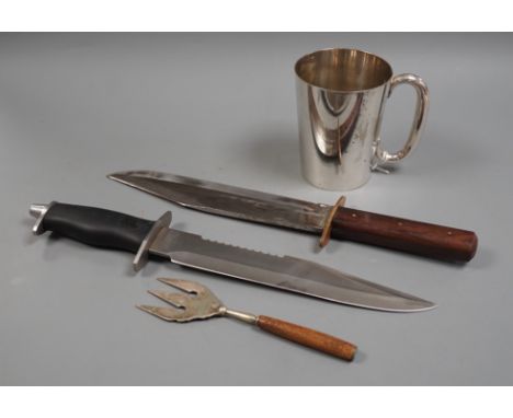 Two Bowie knives and a mug and a fork