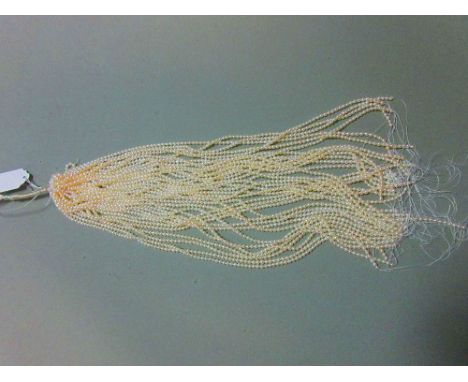 A skein of thirty six strings of 4mm cultured pearls, each string 40.5cm long (one string of 25cm), the pearls variously roun