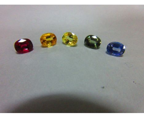 A loose ruby and four loose variously coloured sapphires, all oval to rectangular cushion cut and evenly-matched for size, th