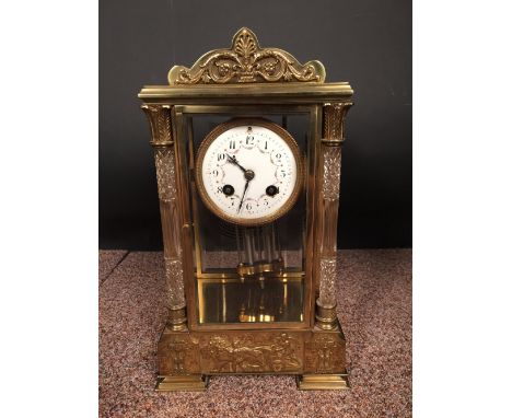A French gilt brass four-glass mantle clock, with swagged enamel 8cm (3in) dial, glass front corner columns and drum shaped g