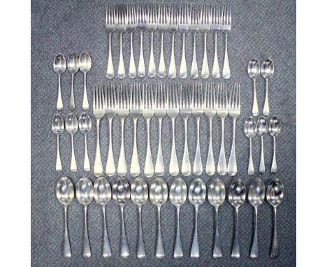 A late Victorian silver Old English pattern flatware service, mostly by Wakely & Wheeler, London 1897, comprising:- twelve ta