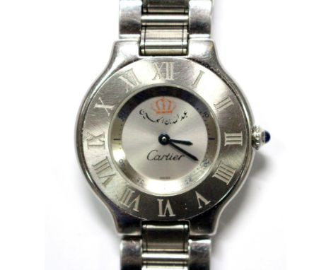 By Cartier - a gentleman's stainless steel 'Must de Cartier 21' quartz bracelet watch. The plain silvered dial with Crown and