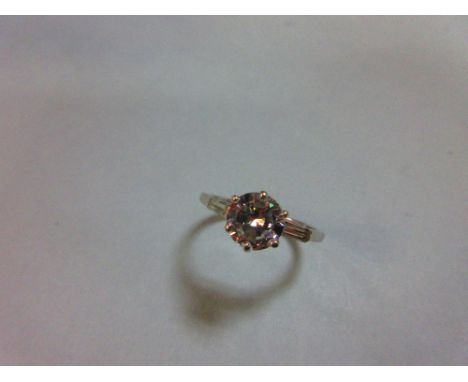 A diamond ring, the round brilliant cut principal stone, estimated weight 1.28cts, with a single baguette cut diamond on each