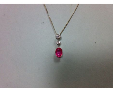 A pink sapphire and diamond pendant set in 18ct white gold, designed as a line of three stones separated by short bars, with 