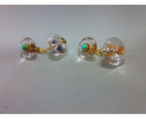 A pair of rock crystal and turquoise cufflinks, each with a circular cabochon turquoise collet set in the dished centre of a 