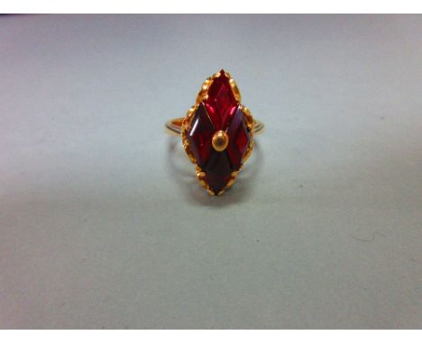 A modern red hardstone ring, the four diaper step cut deep crimson red stones, believed to be synthetic rubies, set in diamon