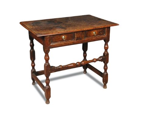 A late 17th century oak side table, fitted a single drawer with panel moulded front, brass ring handles on turned stretchered