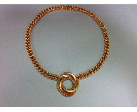 A curb link chain necklace with central knot feature, the knot composed of three square section interlinked rings of bi-colou